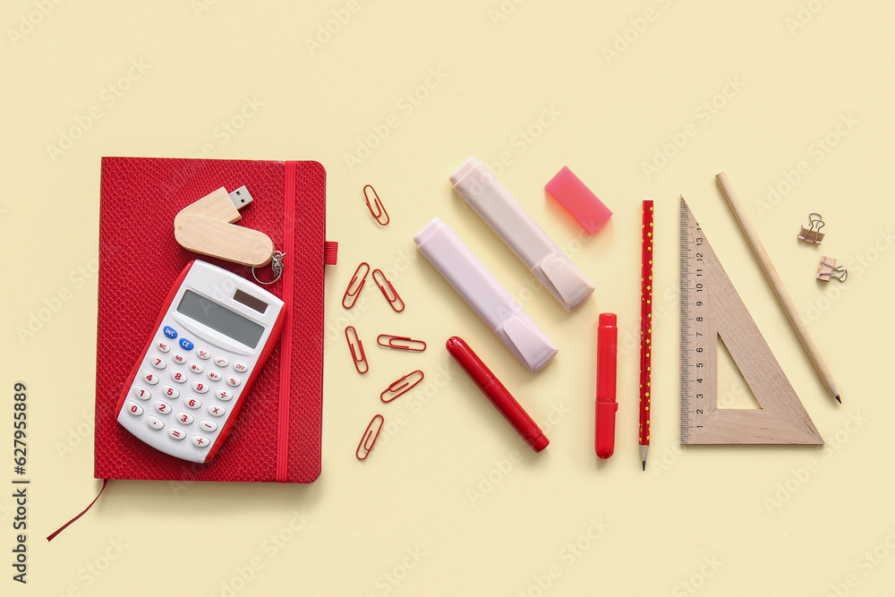 Different school stationery and notebook on beige background