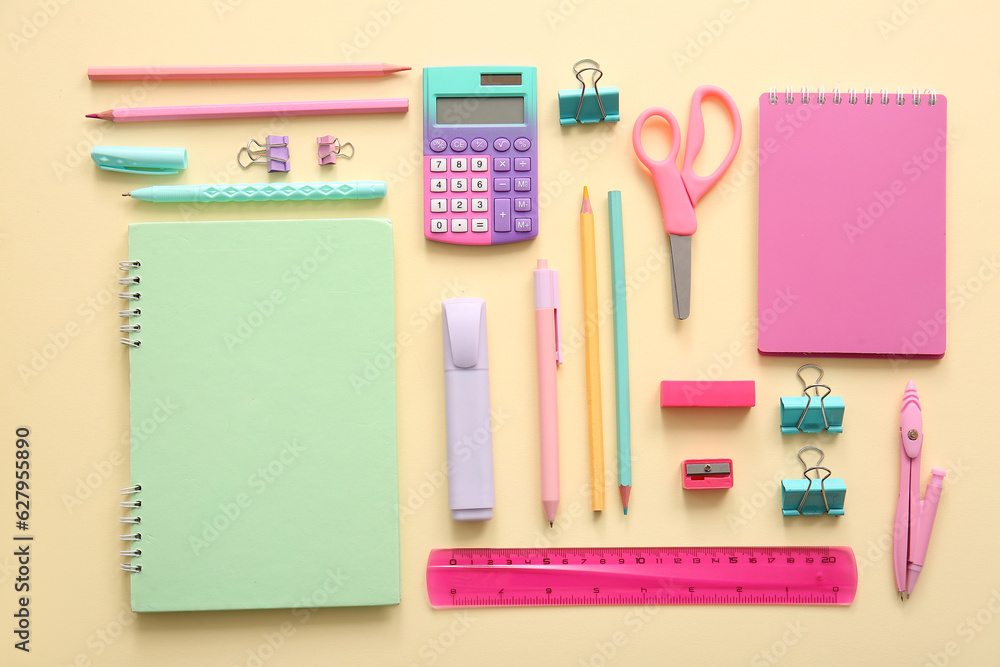 Different school stationery and notebooks on beige background