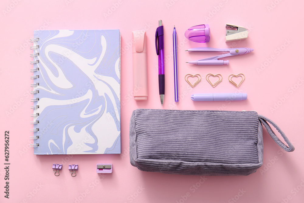 Different school stationery and notebook on pink background