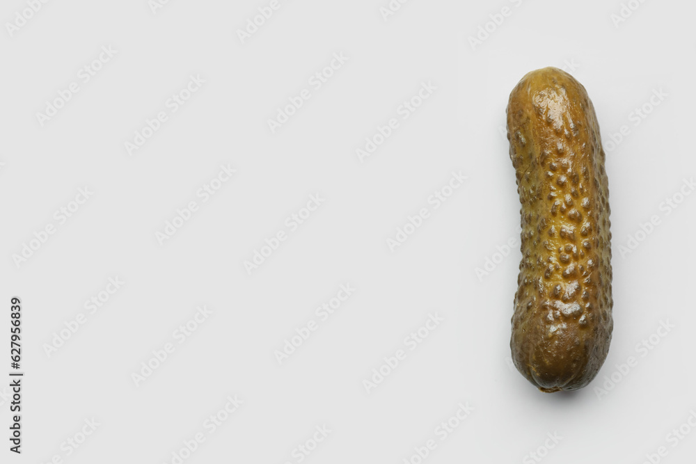 Pickled cucumber on grey background