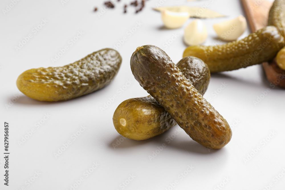 Pickled cucumbers on grey background