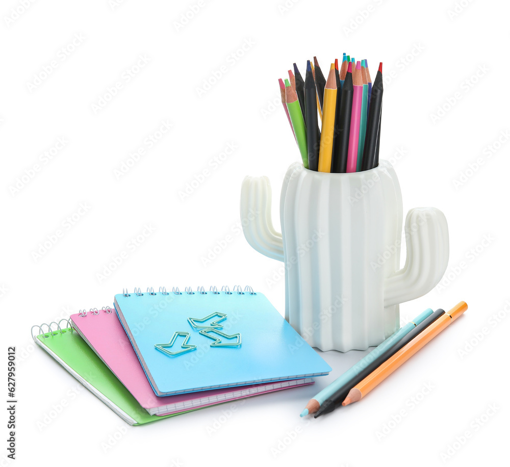 Cup in shape of cactus with school stationery and notebooks on white background