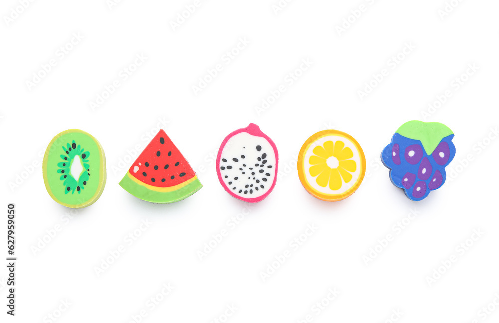 Set of erasers in shape of fruits on white background