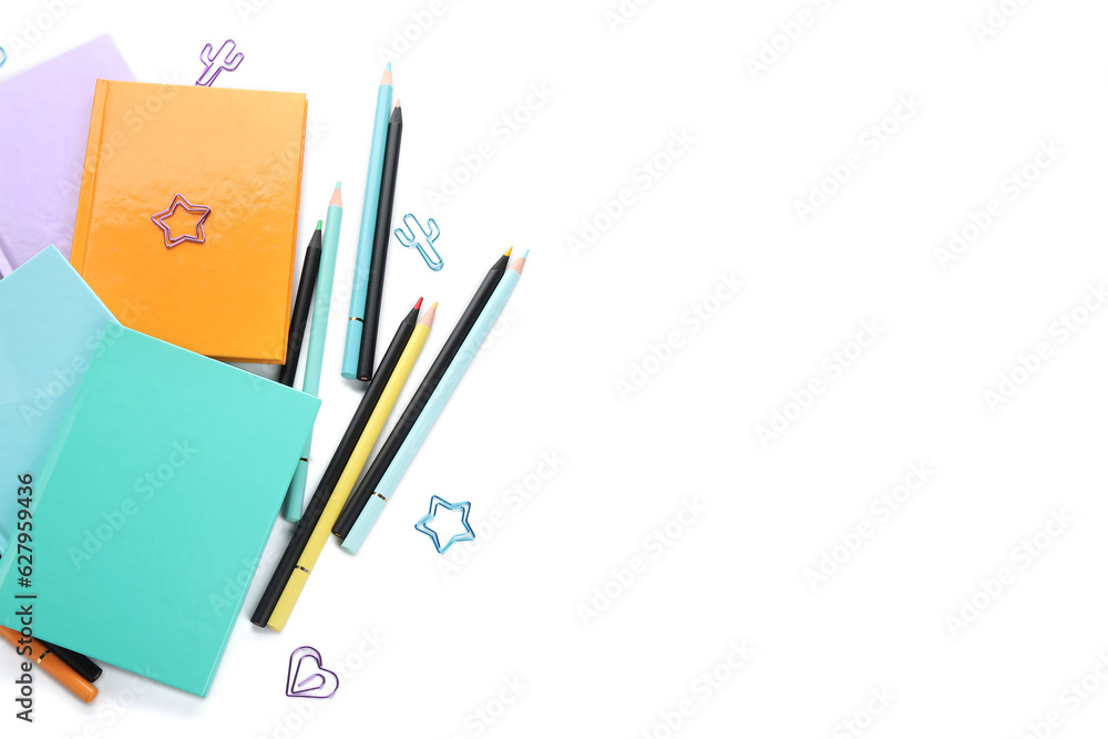 Notebooks and school stationery on white background