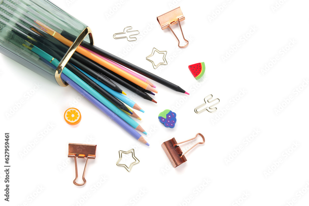 Cup with colorful pencils and paper clips of different shapes on white background