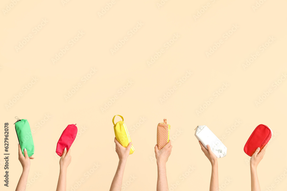 Hands with school supplies on beige background