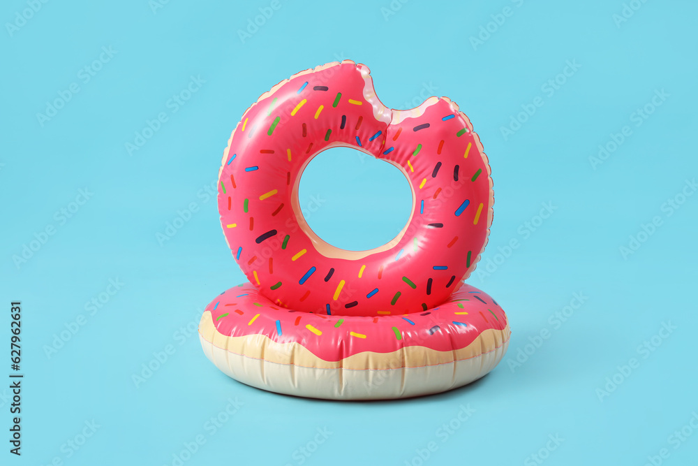 Swim rings in shape of donuts on blue background