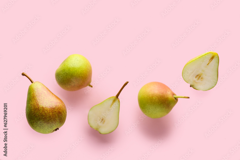 Flying ripe pears on pink background