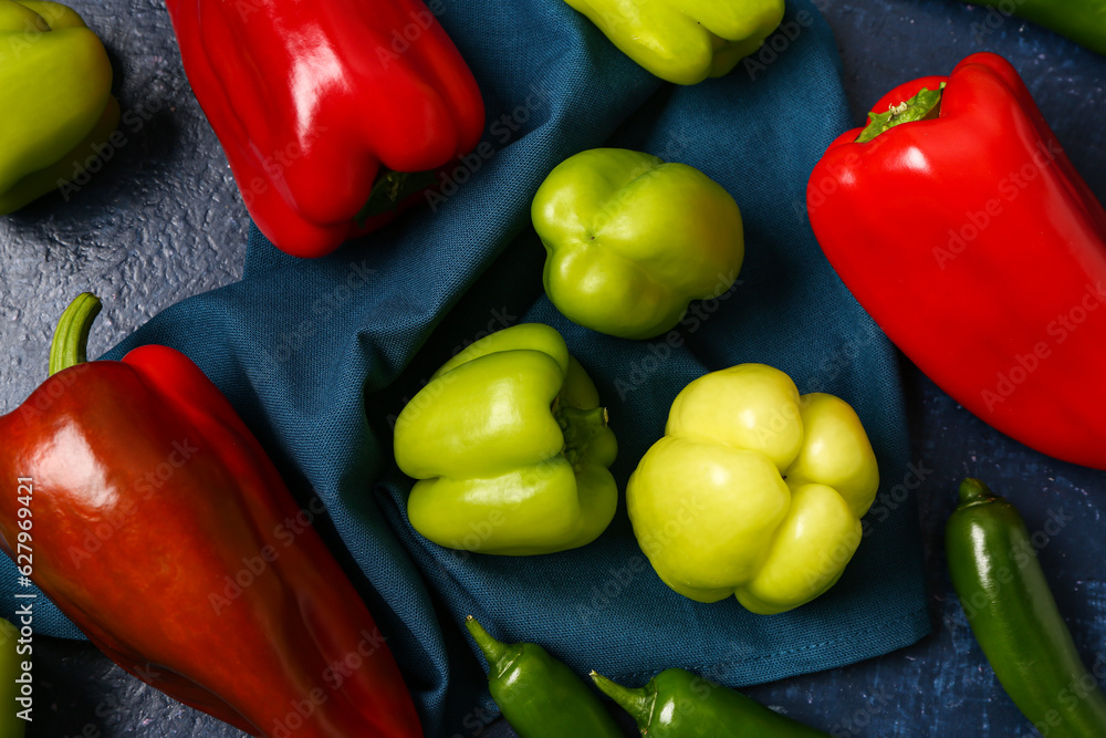 Different fresh peppers on blue background