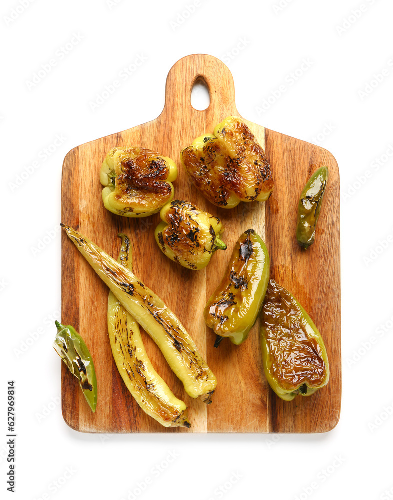 Wooden board with different grilled peppers on white background