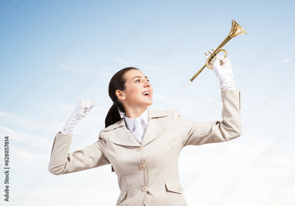 Beautiful woman holding trumpet brass overhead