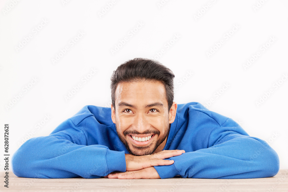 Thinking, wonder and face of man on a white background with ideas, brainstorming and dream by table.