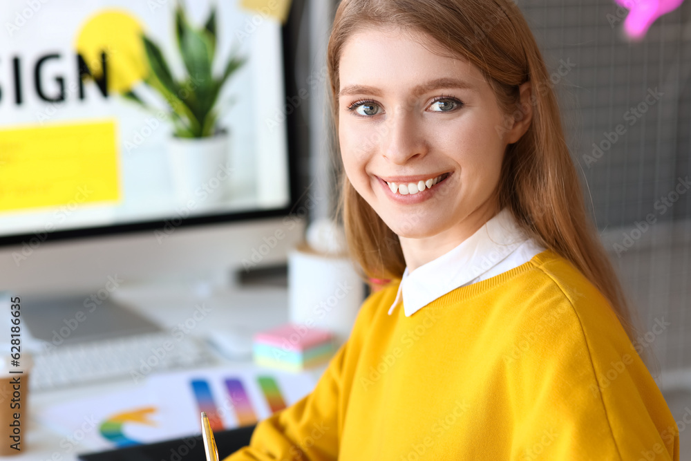 Female graphic designer working in office, closeup