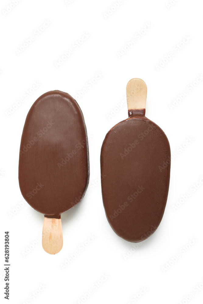 Delicious chocolate covered ice cream on stick against white background