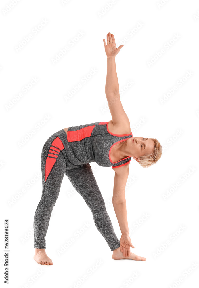 Sporty mature woman practicing yoga on white background