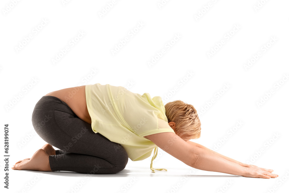 Sporty mature woman practicing yoga on white background