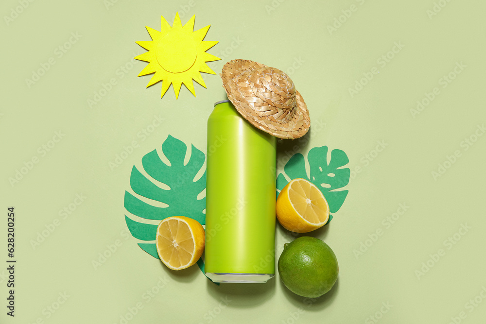 Can of soda with hat, citrus fruits, paper palm leaves and sun on green background