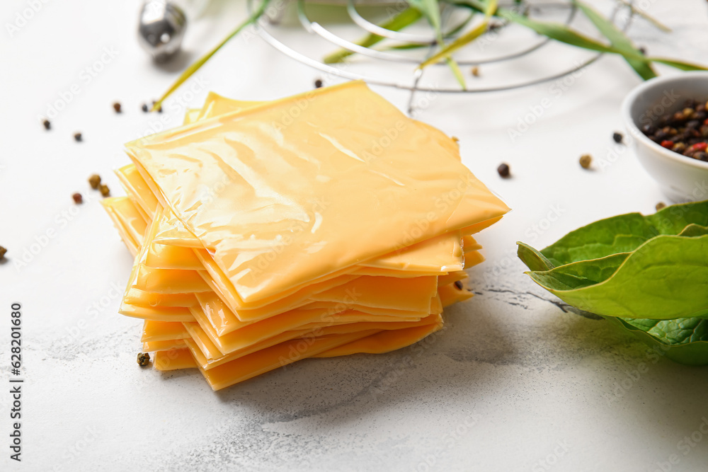 Slices of tasty processed cheese on white marble background