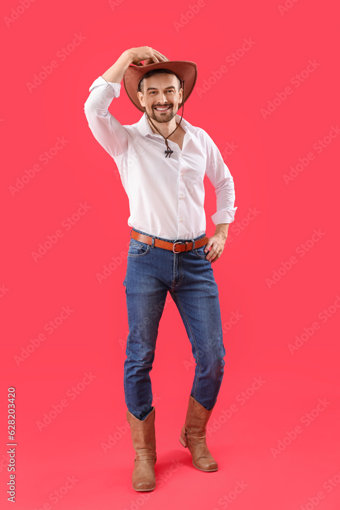 Handsome cowboy on red background