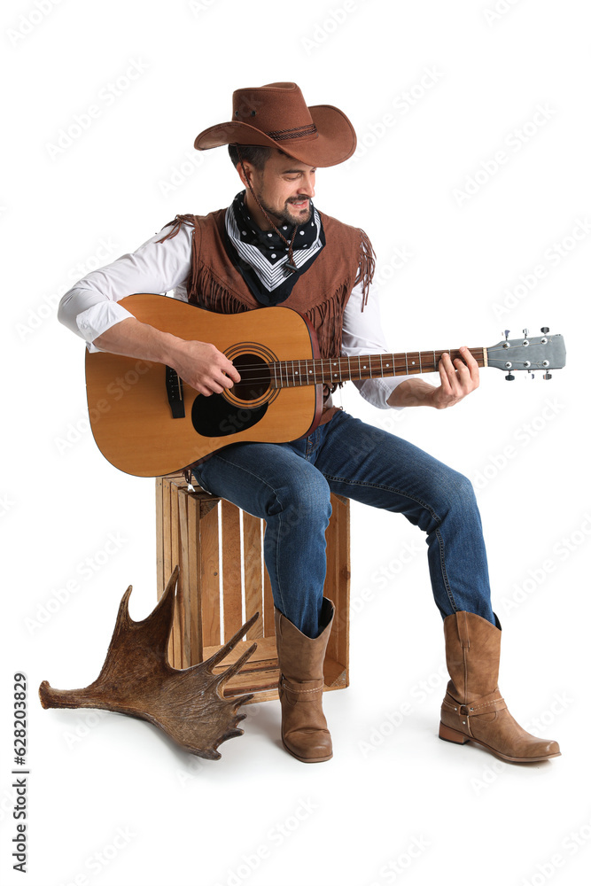 Handsome cowboy playing guitar on white background