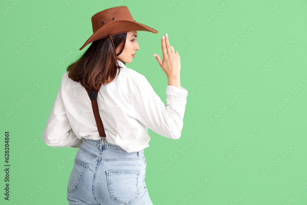 Beautiful cowgirl on green background