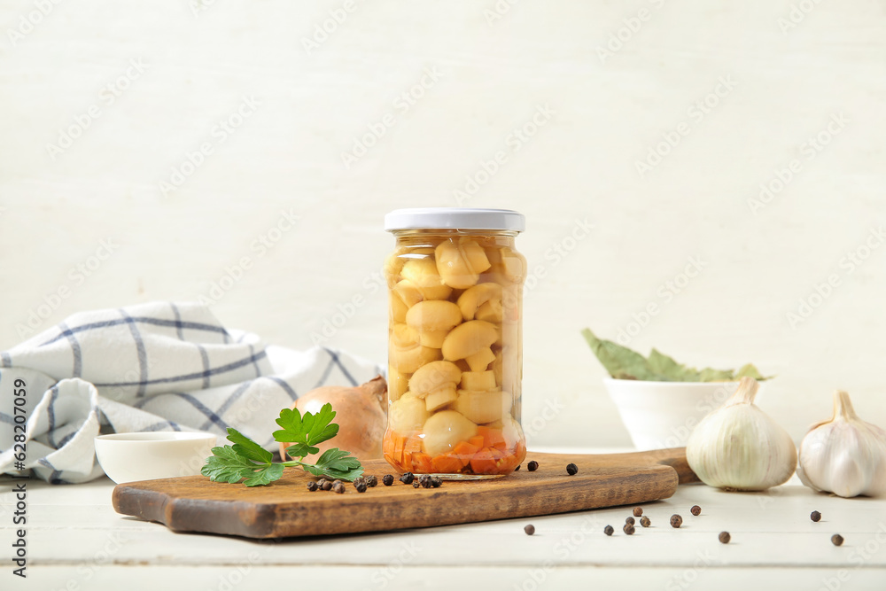 Jar with canned mushrooms on table