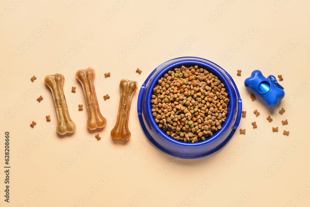 Composition with dry dog food, treats and waste bags on color background