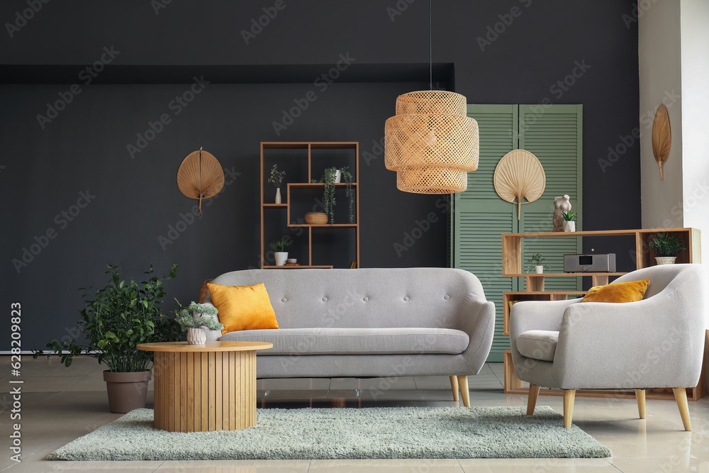 Interior of modern living room with grey sofa, armchair and wooden coffee table