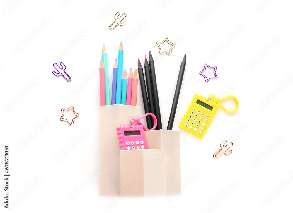 Cups with school stationery on white background