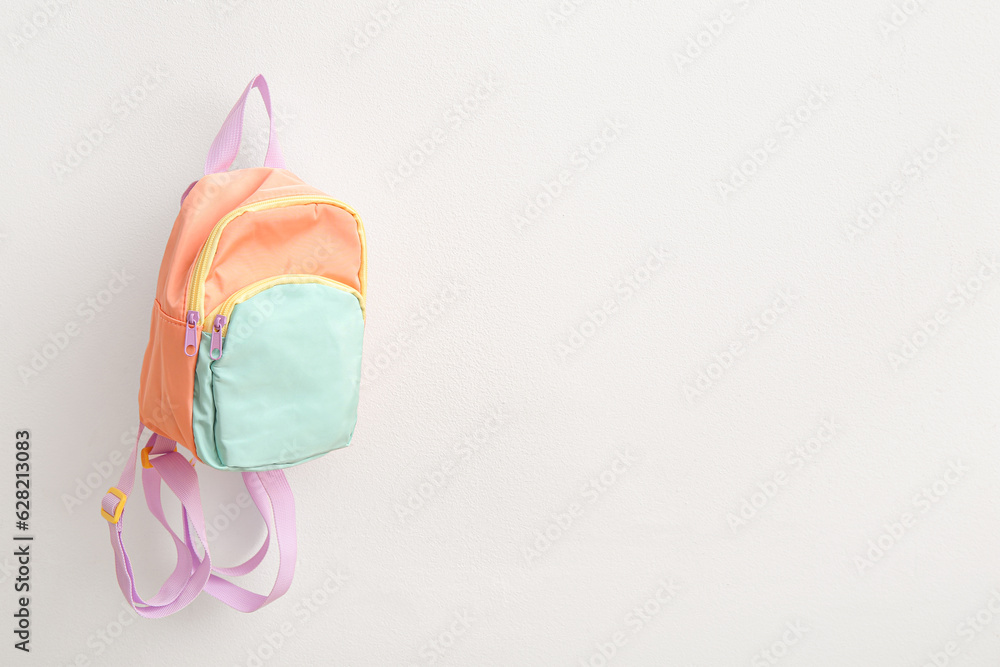 Color school backpack on white background