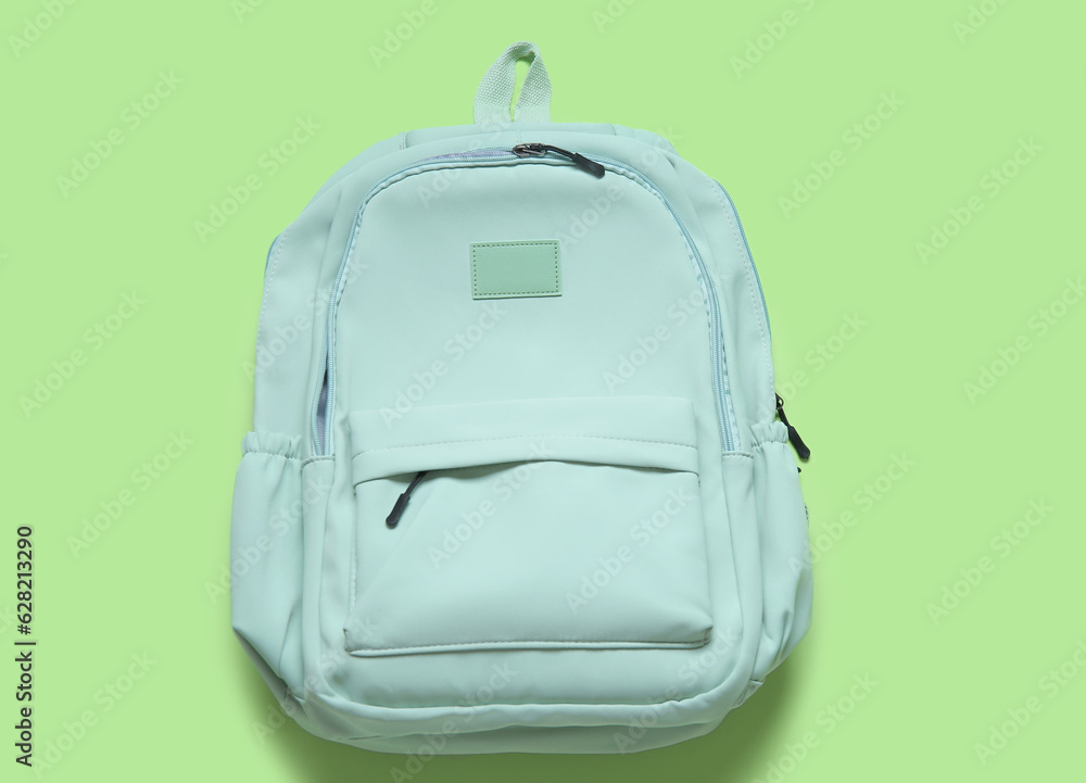 School backpack on green background