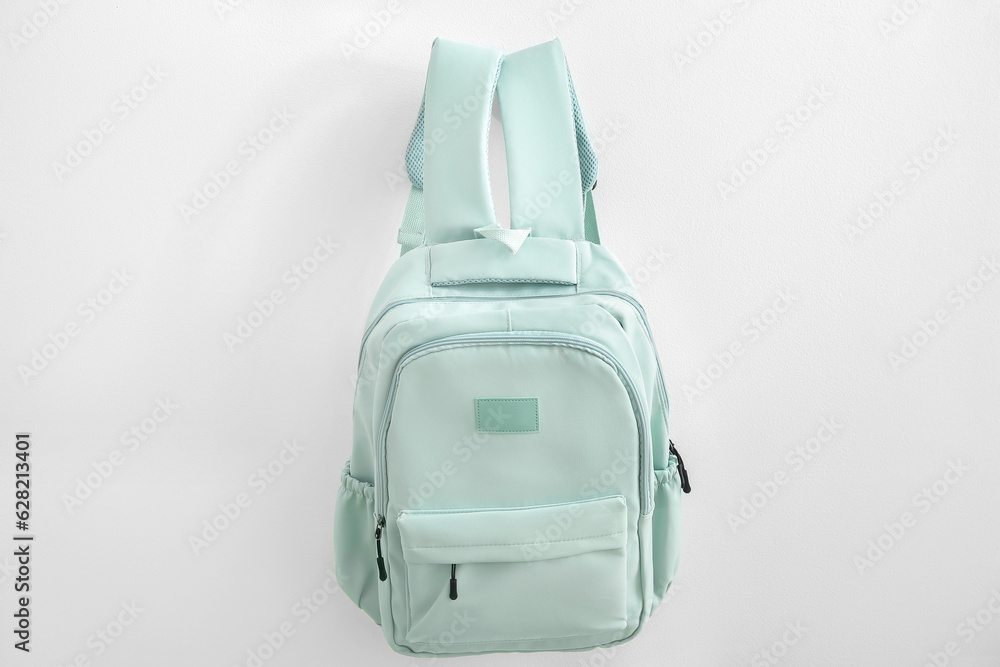 Green school backpack on white background