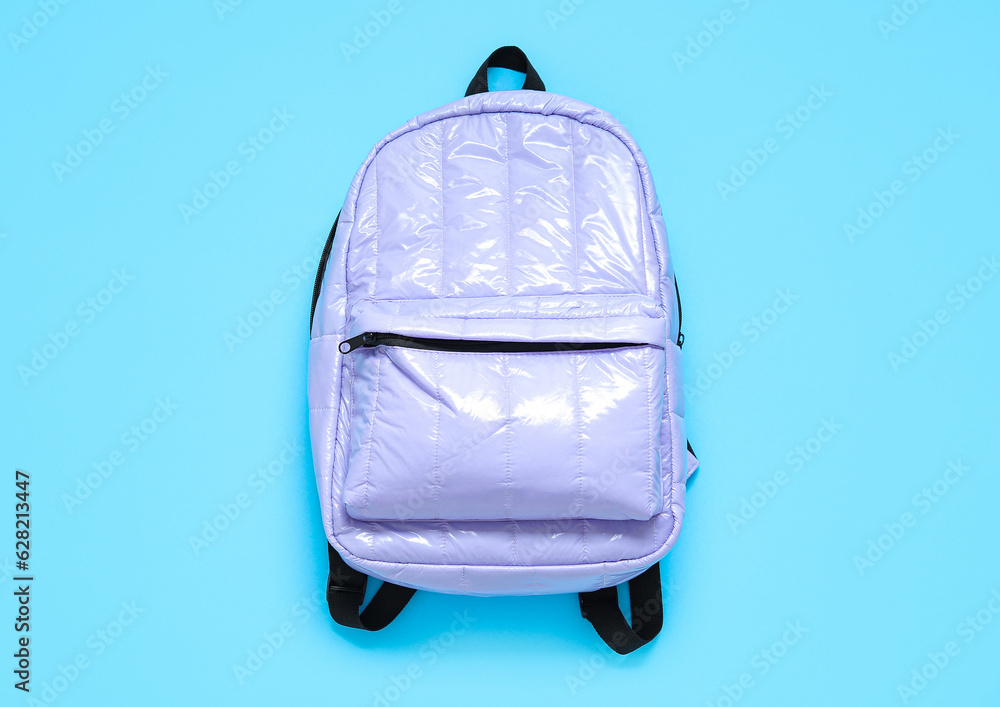 Lilac school backpack on blue background