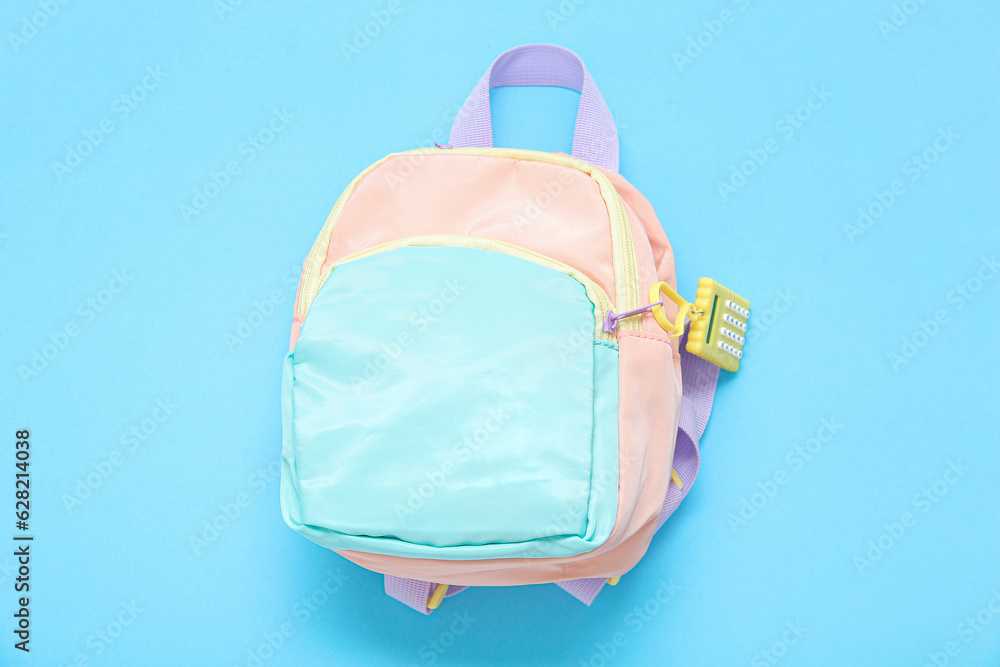 Color school backpack on blue background