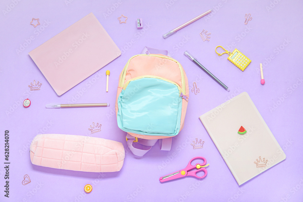 Color school backpack with different stationery on lilac background