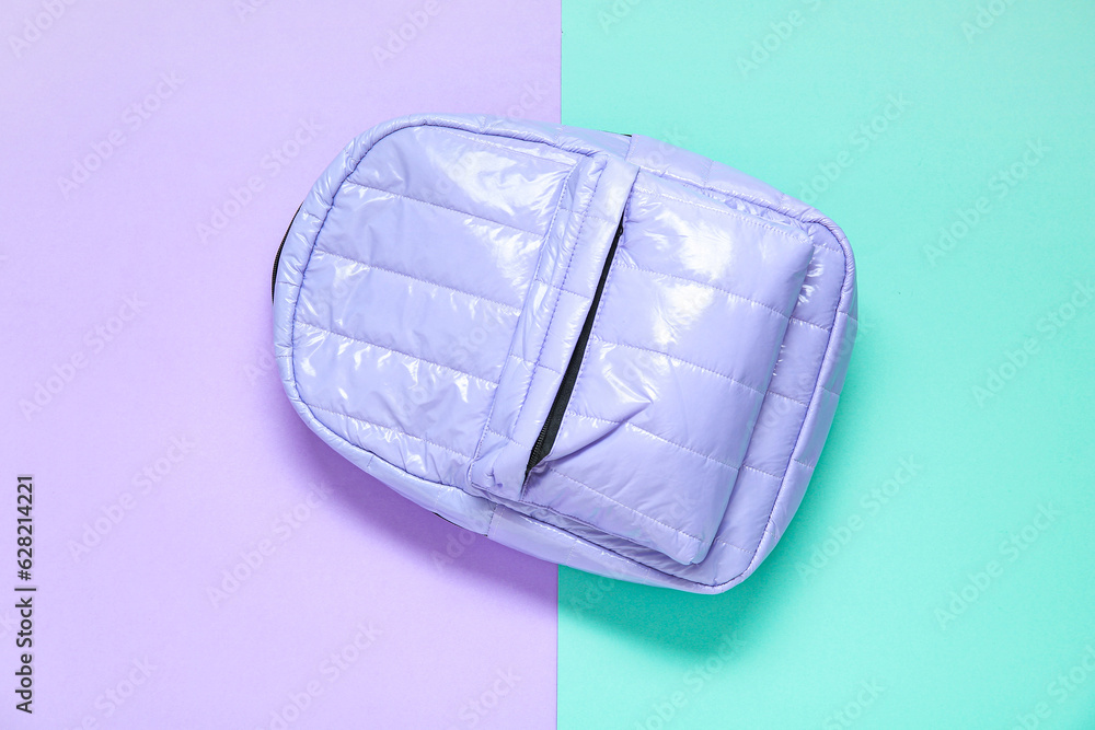 Lilac school backpack on color background