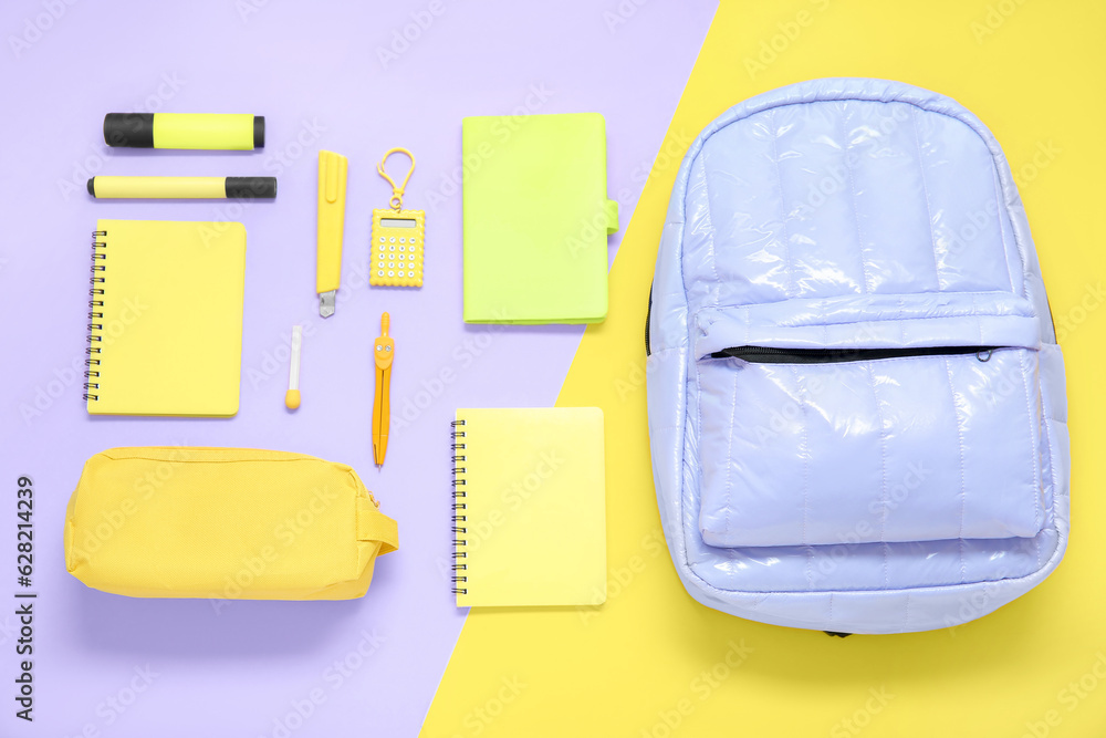 Lilac school backpack with different stationery on color background