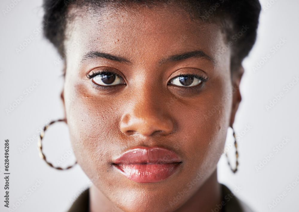 Serious, beauty and face of black woman with confidence on a white background in studio closeup. Stu