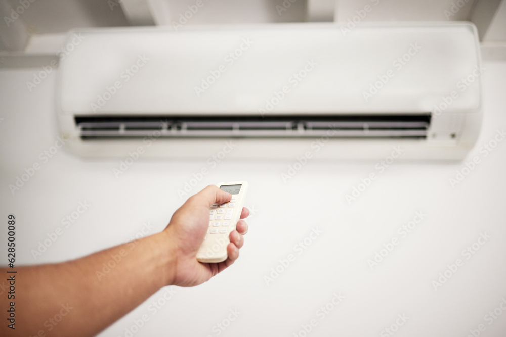 Air conditioner, hand and remote for electrical machine check with person in a home with ac repair. 