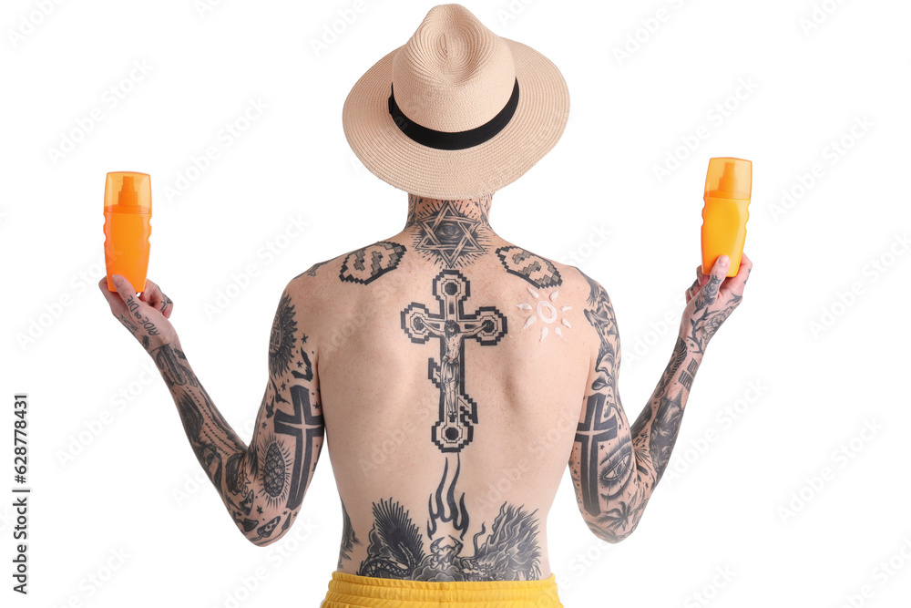 Tattooed man with sunscreen creams on white background, back view