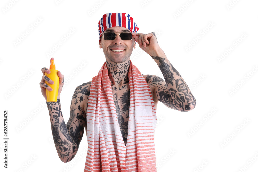 Tattooed man with sunscreen cream on white background