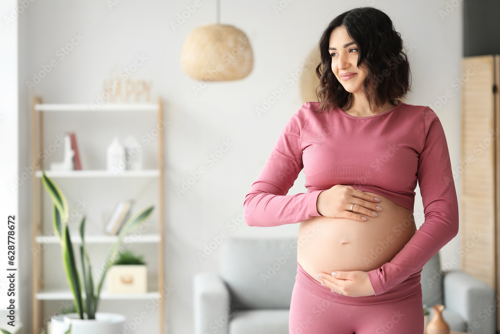 Sporty pregnant woman at home