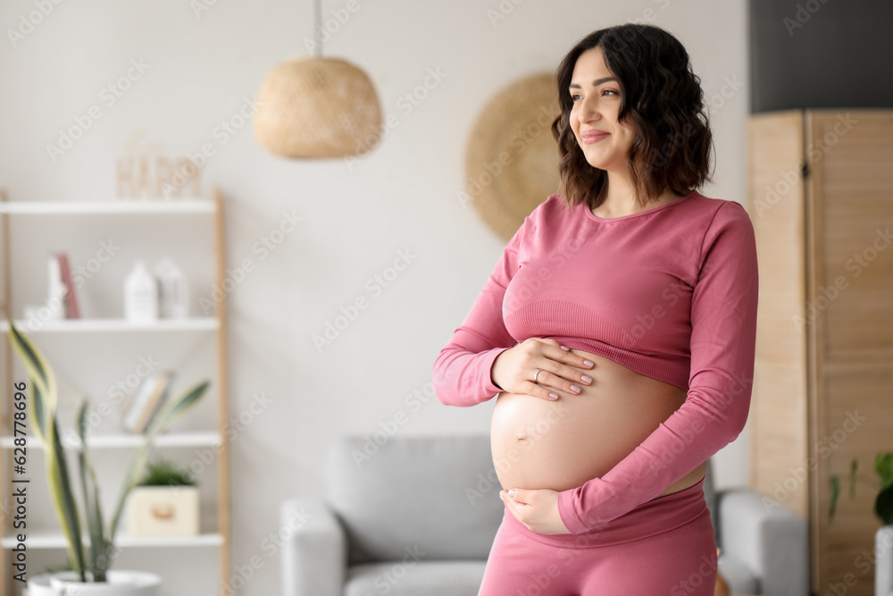 Sporty pregnant woman at home