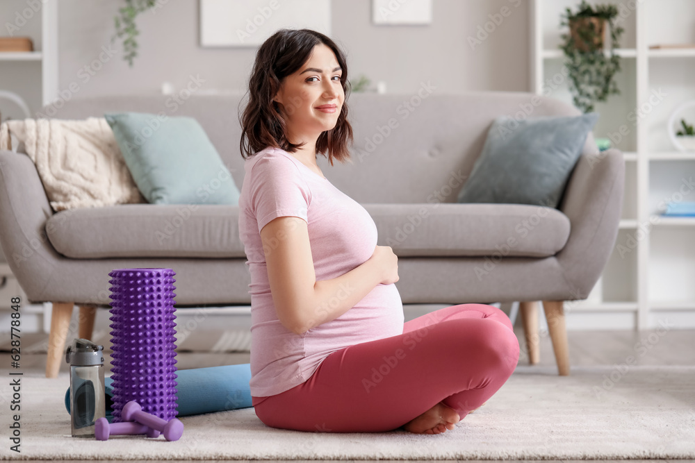 Sporty pregnant woman at home