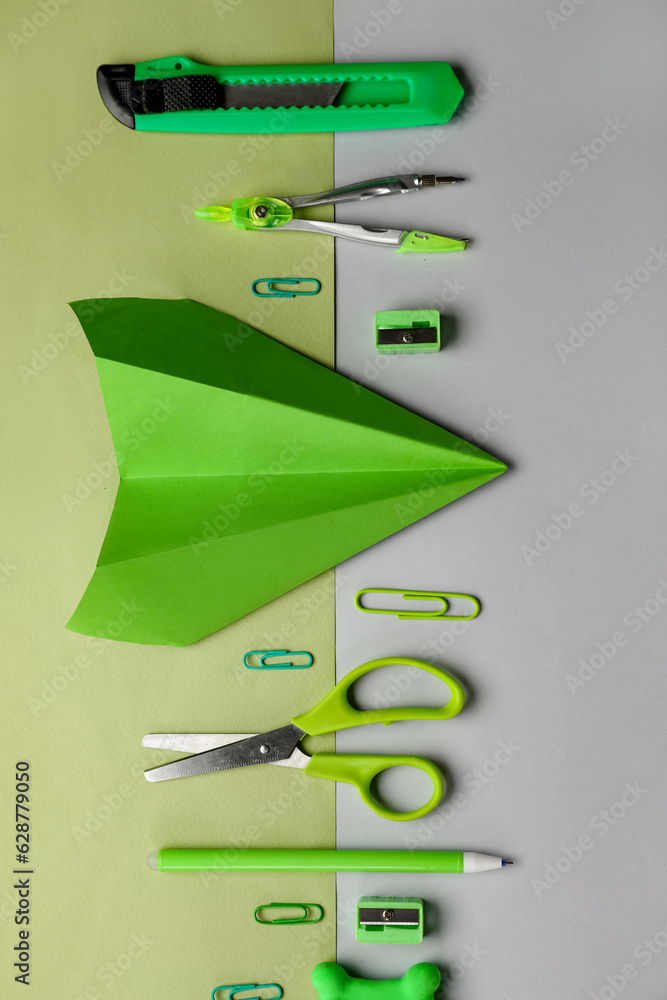 Composition with stationery supplies and paper planes on color background