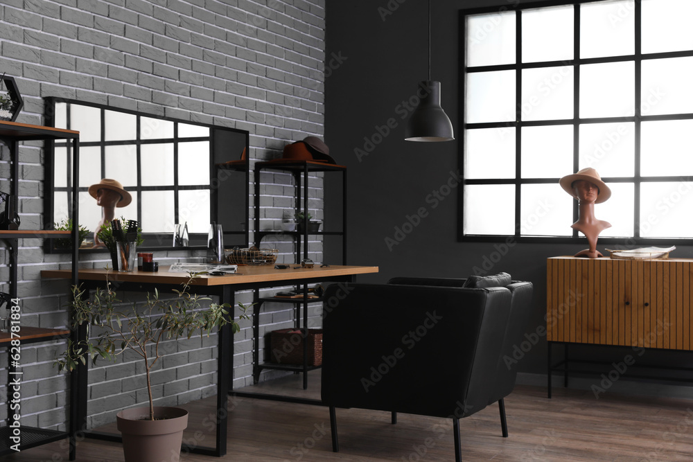 Interior of beauty salon with comfortable armchair, table and mirror