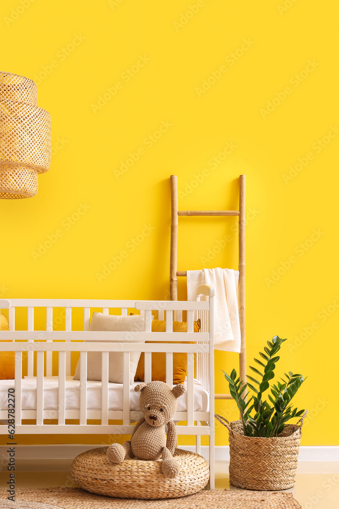 Interior of stylish bedroom with baby crib and ladder