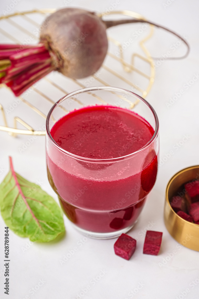 Glass of fresh beetroot juice on white background