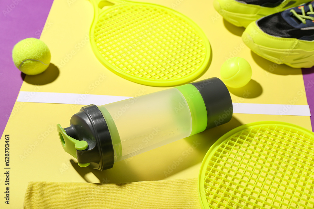 Composition with bottle of water and sports equipment on color background, closeup