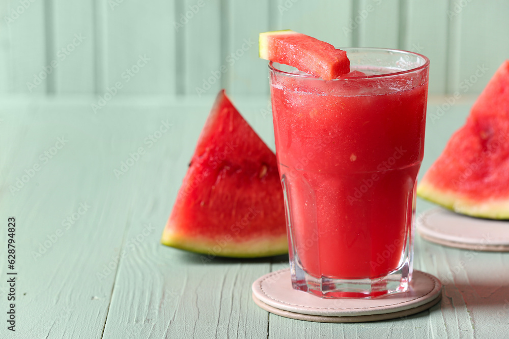 Glass of tasty watermelon fresh on green wooden background